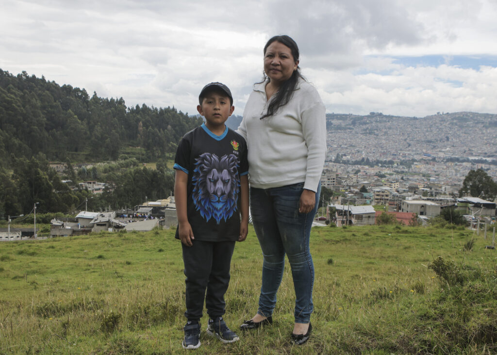 Boy treated for clubfoot poses with his mother.