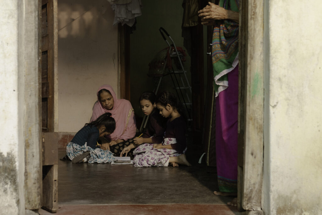 A mother studies with her three daughters who were born with clubfoot in Sri Lanka.