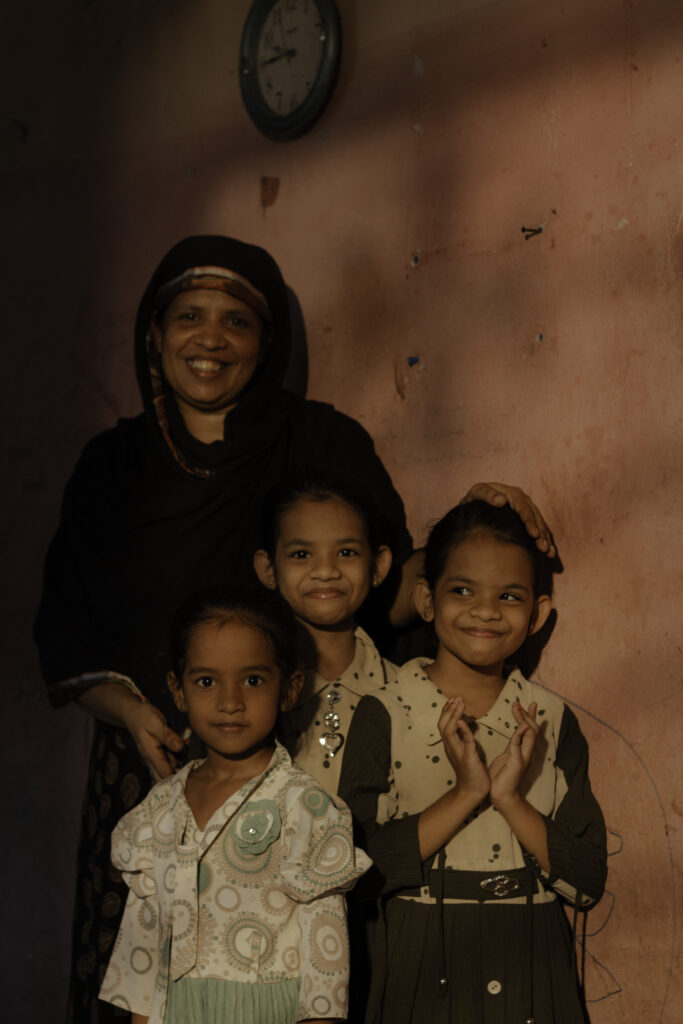 A mother in Sri Lanka poses with her three daughters who were born with clubfoot.